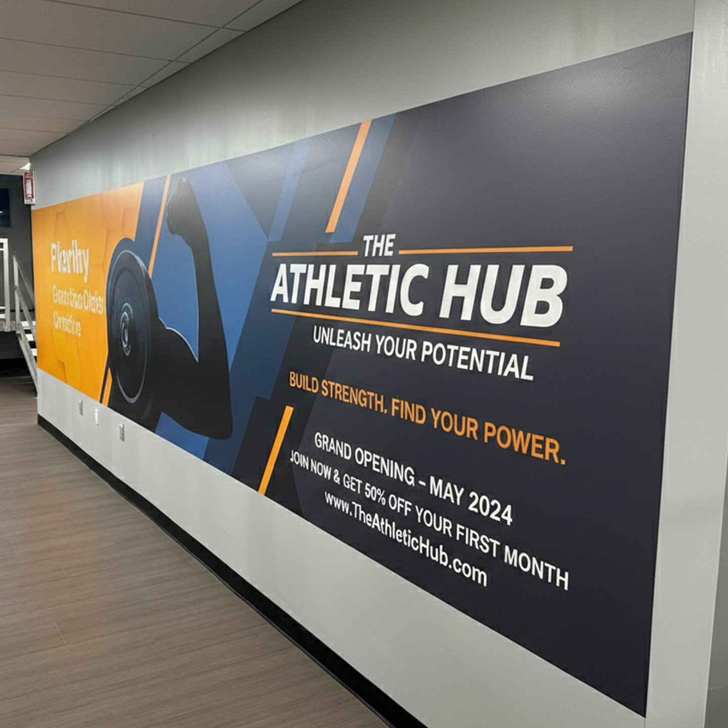 Advertisement for The Athletic Hub on a wall in an indoor setting