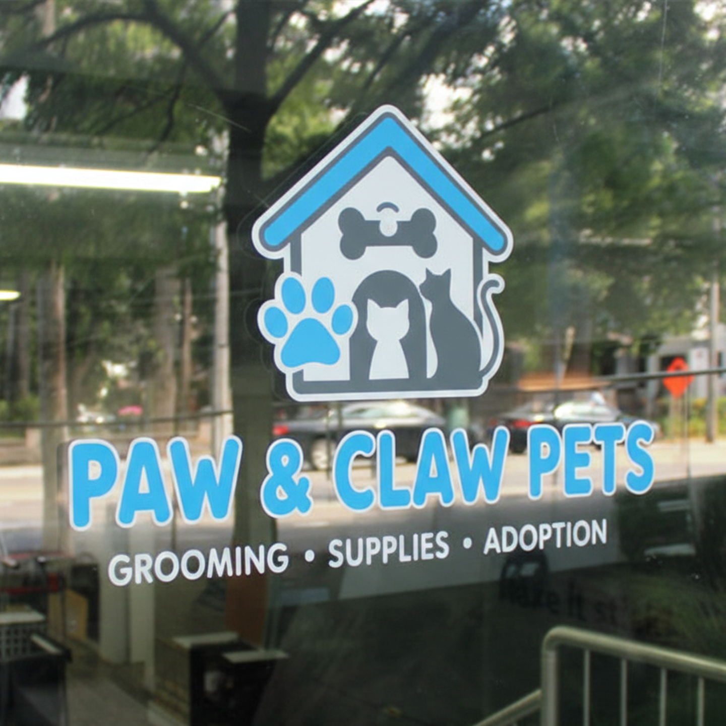 Window decal for Paw & Claw Pets with grooming, supplies, and adoption services.